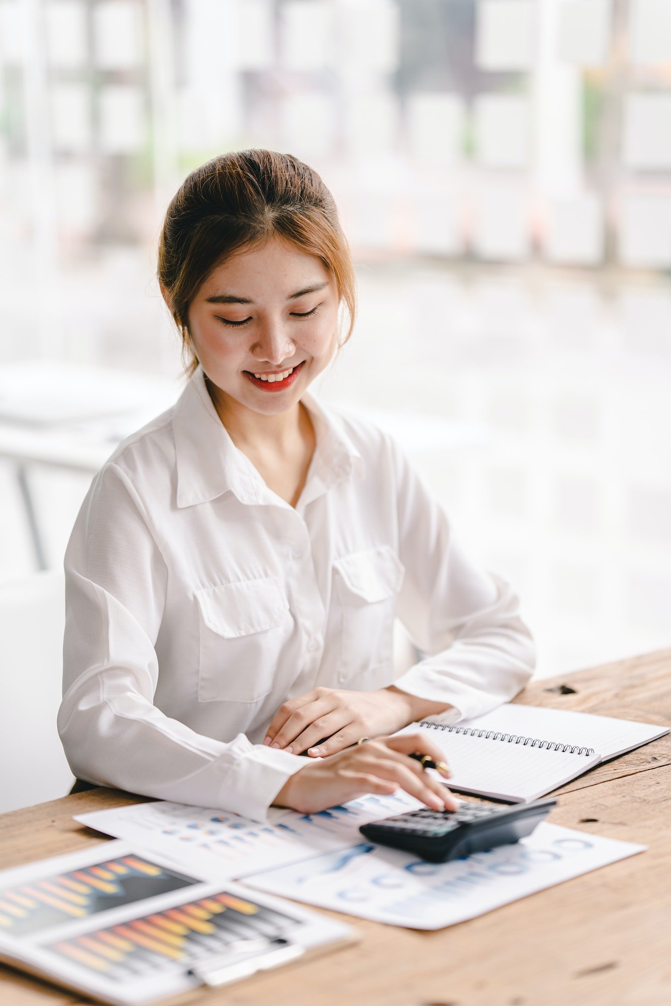 portrait-of-an-asian-woman-working-on-a-tablet-computer-in-a-modern-office-make-an-account-analysis.jpg