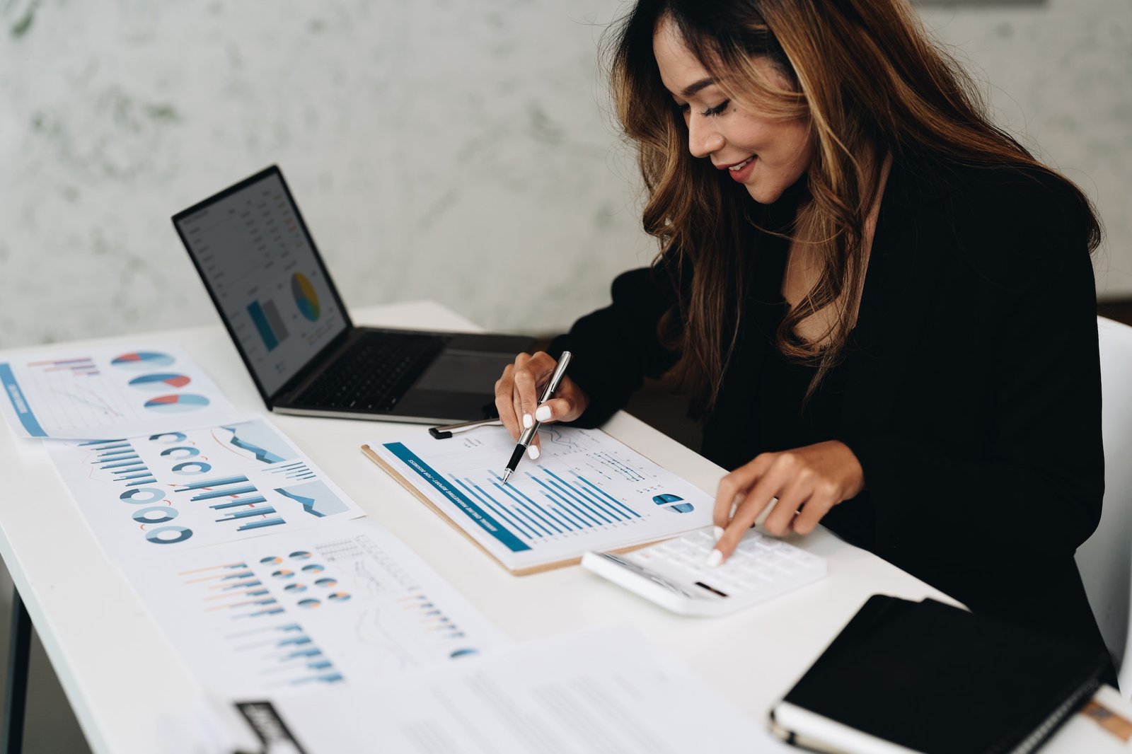 usiness-analyzing-investment-charts-with-calculator-laptop-accounting-and-technology-in-office.jpg